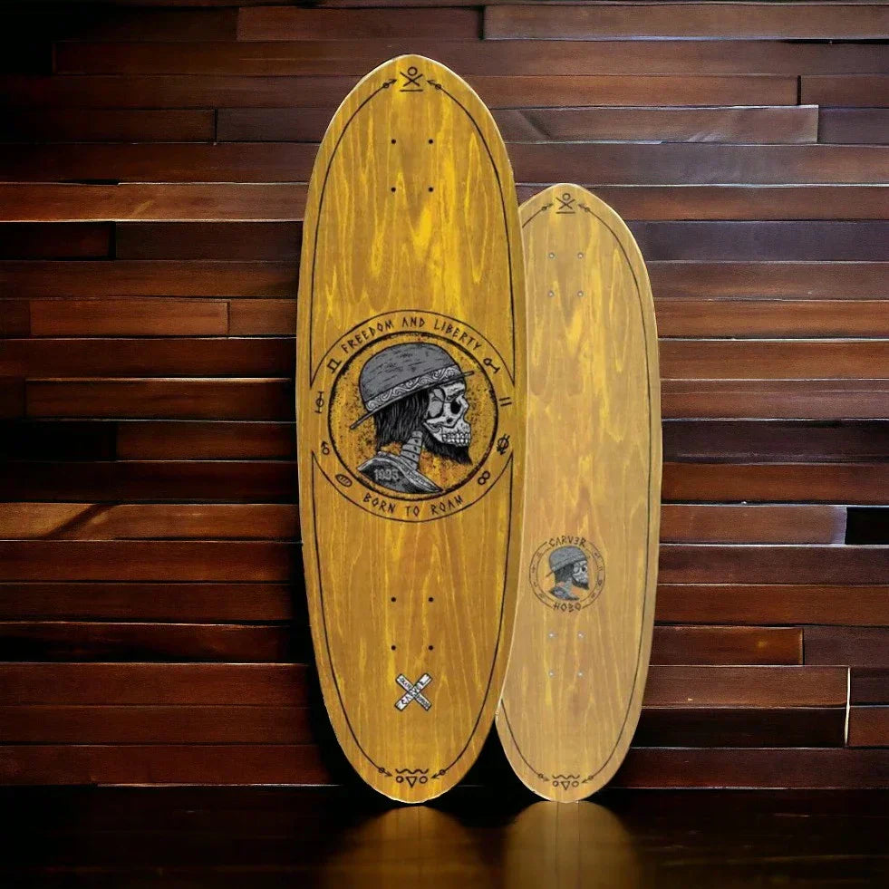 Two wooden Carver surf skate decks with skull graphic and freedom and liberty text on dark wooden background