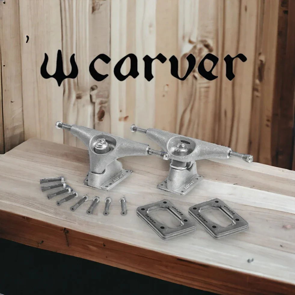 Carver skateboard trucks and mounting hardware displayed on a wooden table with wooden background