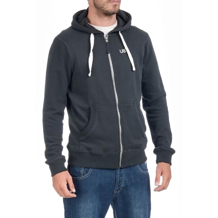 Man wearing black zip-up hoodie with white drawstrings and blue jeans on white background