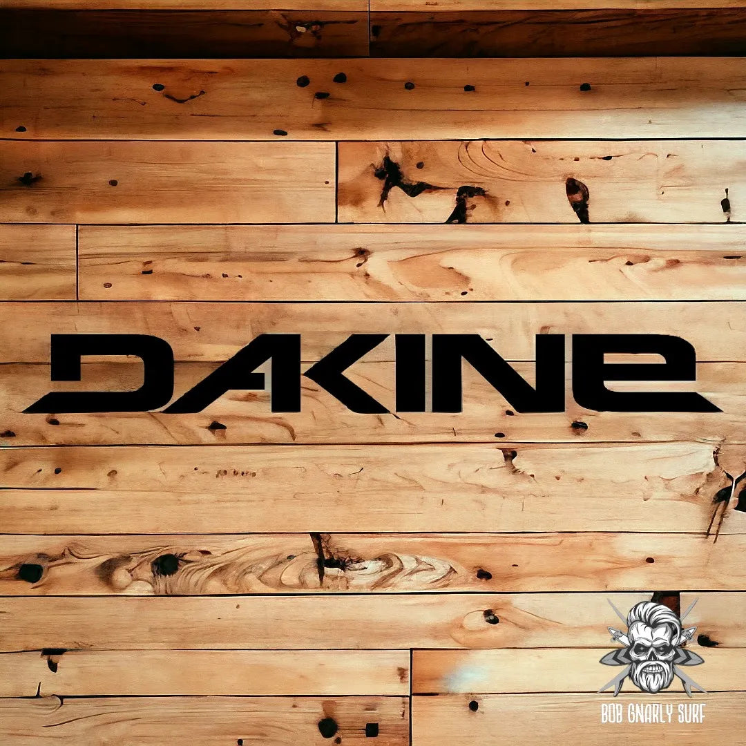 Black Dakine logo on rustic wood plank background with Bob Gnarly Surf skull emblem
