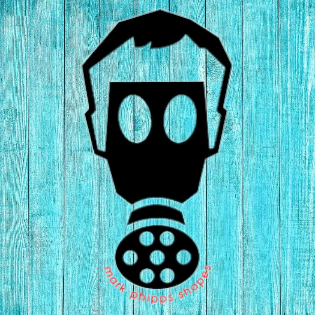 black gas mask stencil with large eye lenses on turquoise wooden background, text mark phipps shapes