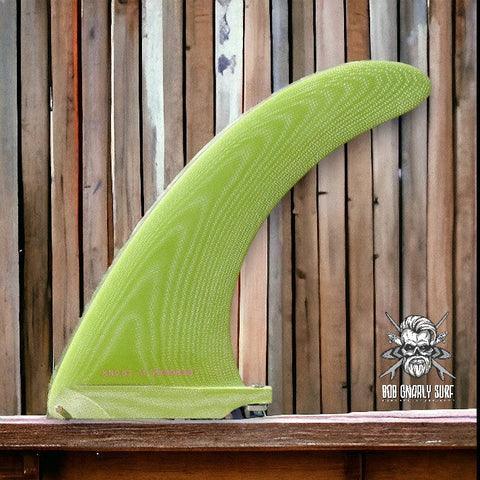 Bright green single surfboard fin displayed against vertical wooden panel background with Bob Gnarly Surf logo