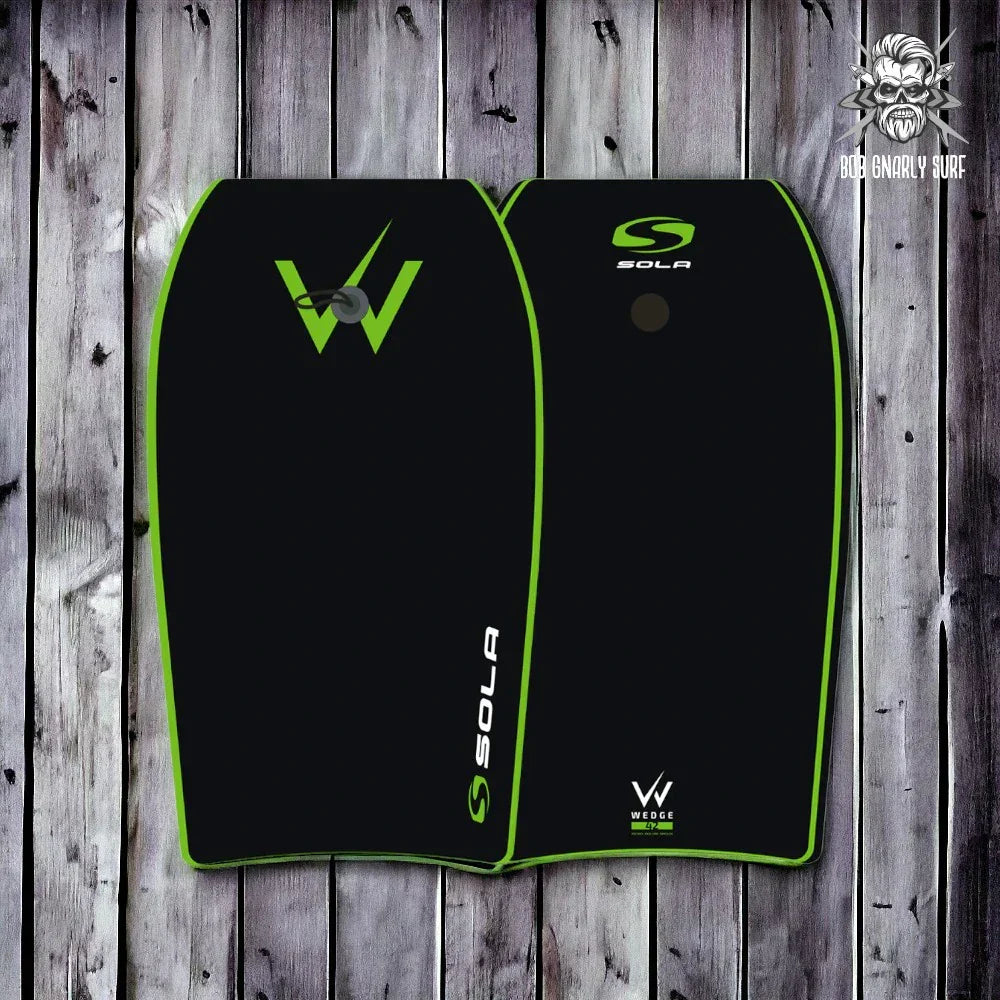 Black and green Sola bodyboards with Wedge design, displayed on wooden background