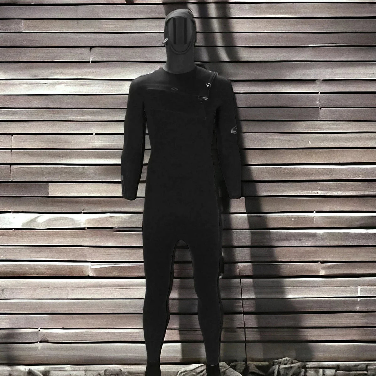 Black full-body wetsuit with attached hood displayed against horizontal wooden slat wall