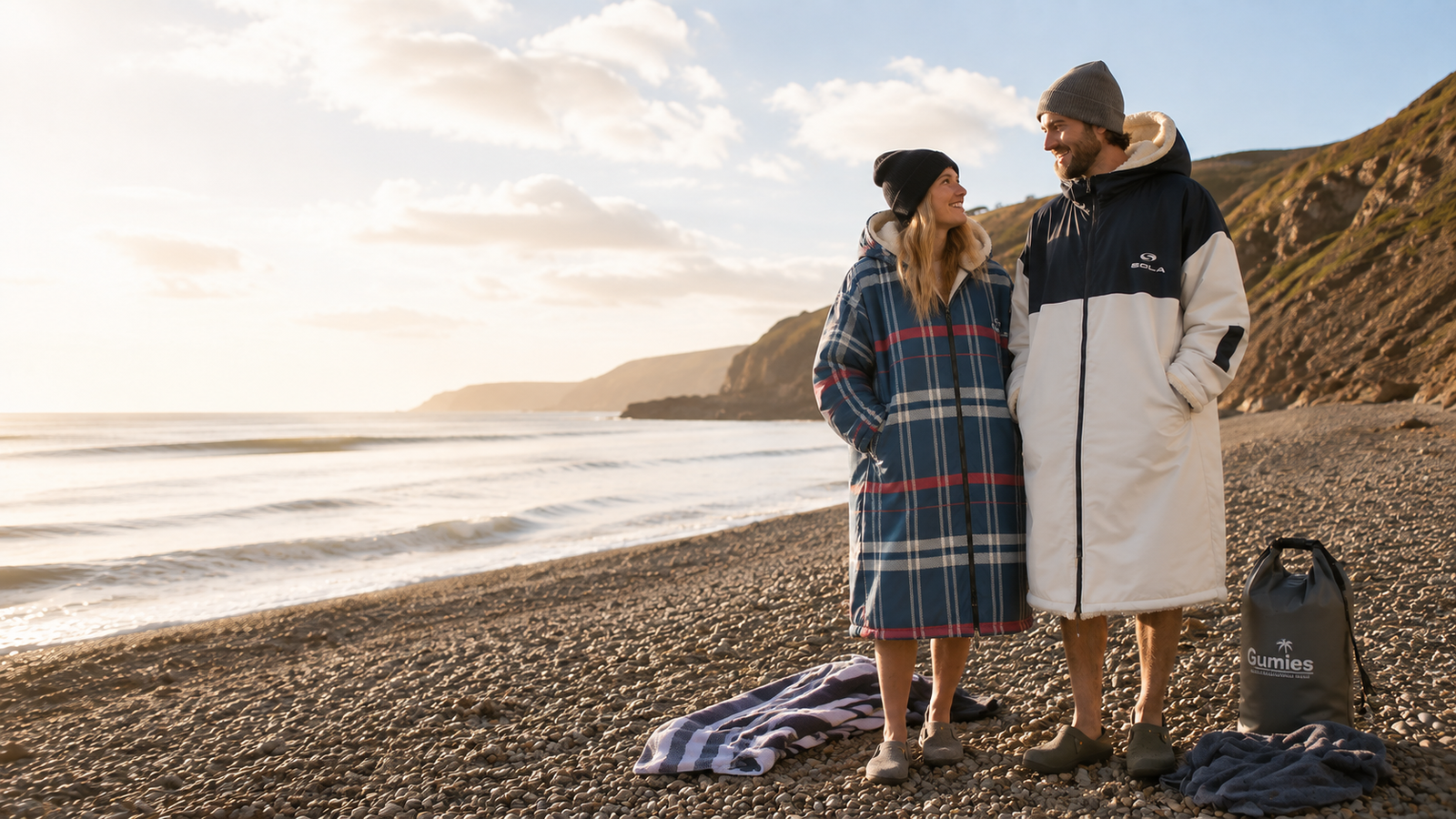 Woman wearing black hooded surf changing robe with gray fleece lining and leopard print shorts