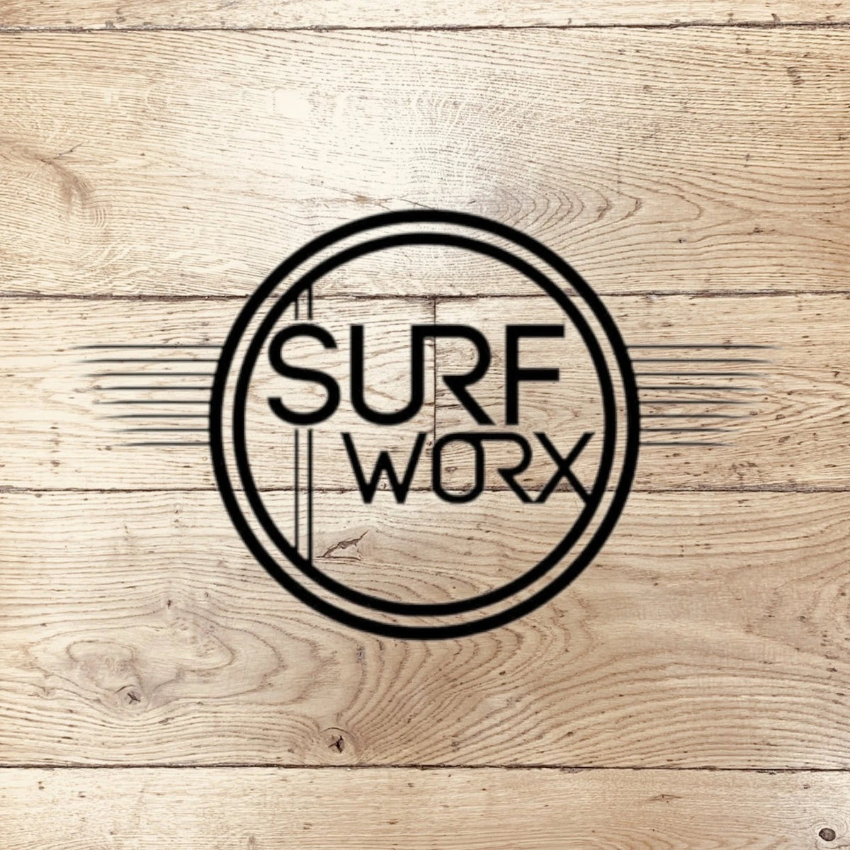Surf Worx black circular logo with stylized text on light wooden planks background
